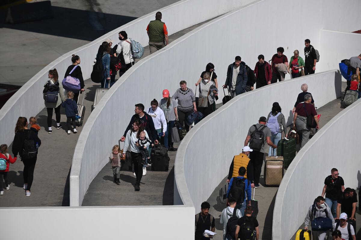 Ukrainian refugees are bused from the Deportivo Benito Juarez shelter to the Chaparral border crossing to enter the U.S.