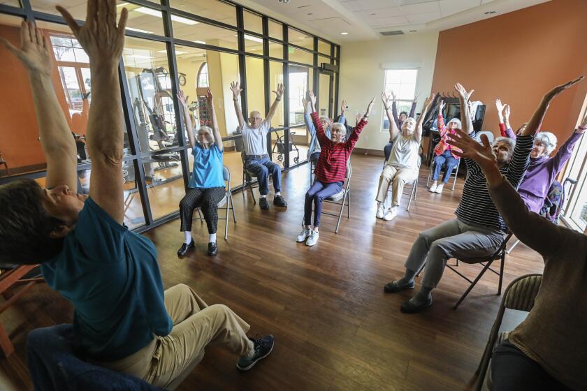 Residents at the St. Paul's Plaza independent and assisted living facility attend the Gentle Stretch class led by fitness coordinator Janet Blair (left) on March 10, 2020 in Chula Vista, California. Residents of the facility are staying active despite cancelation of all activities involving members of the public coming to the facility. Students from High Tech High were scheduled to attend the facility but the event was cancelled.