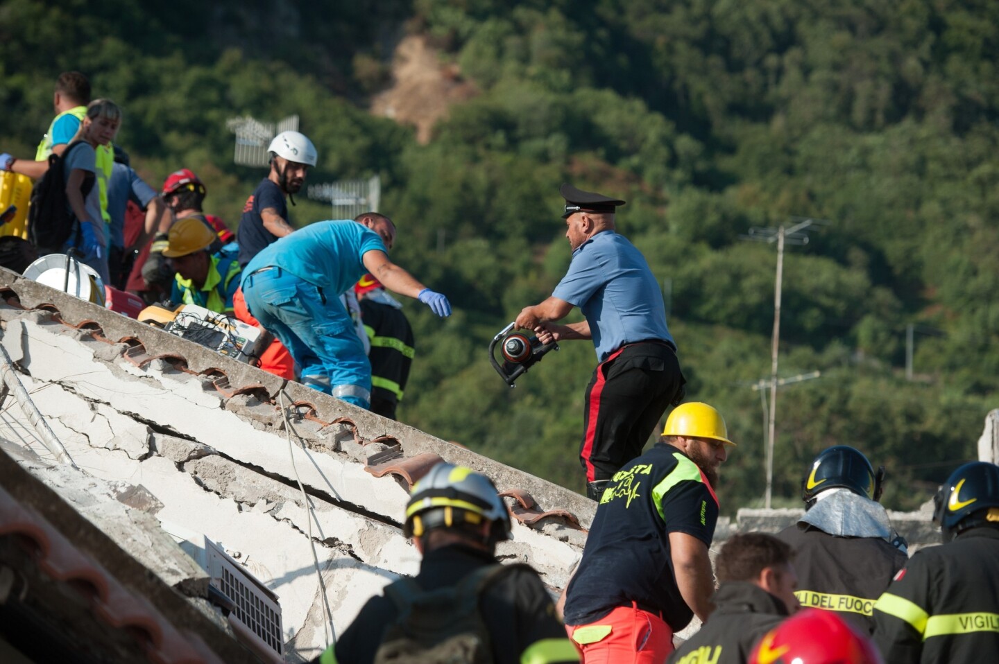 Rescuers dig through the rubble during a search for two missing children in Casamicciola Terme, Italy.
