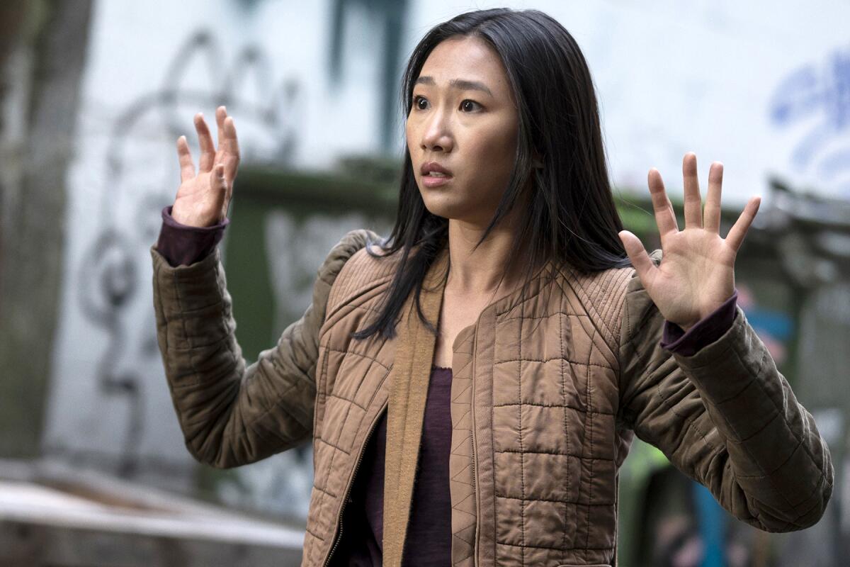 Olivia Liang with both hands raised in "Kung Fu" on the CW.