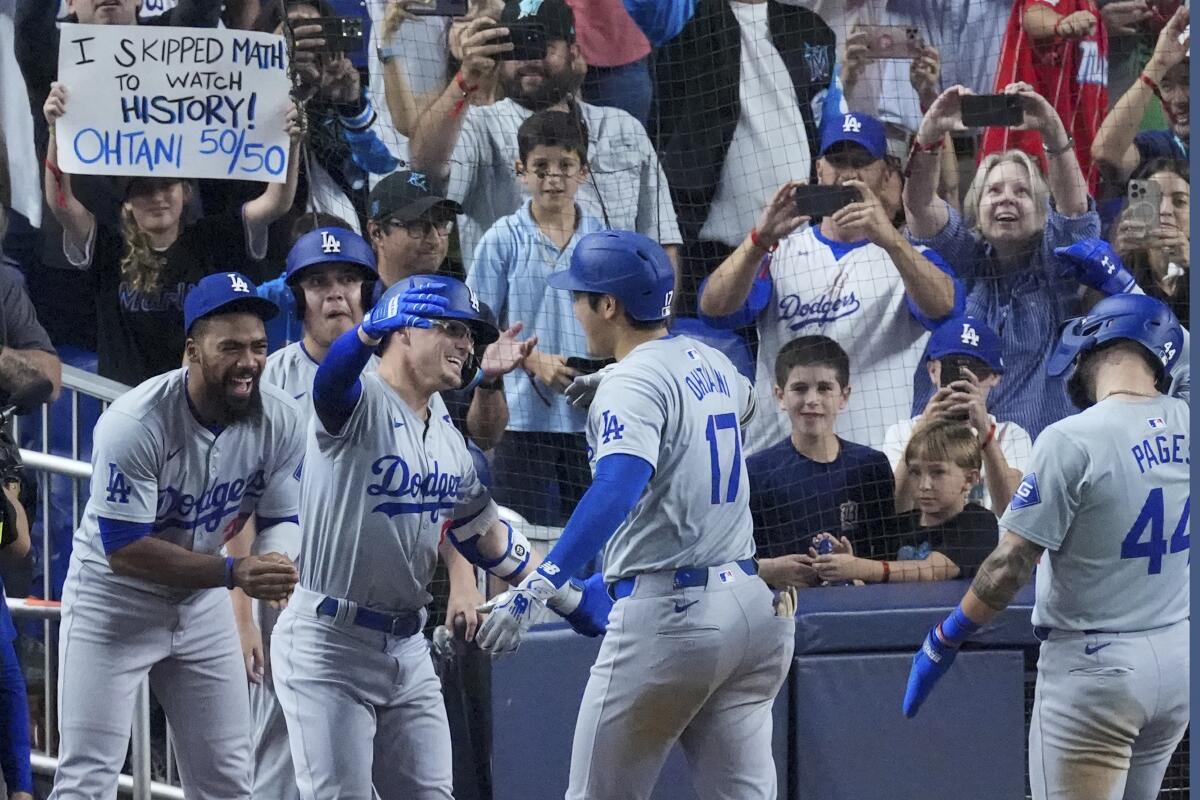 Shohei Ohtani is congratulated by teammates after homering in the seventh inning.