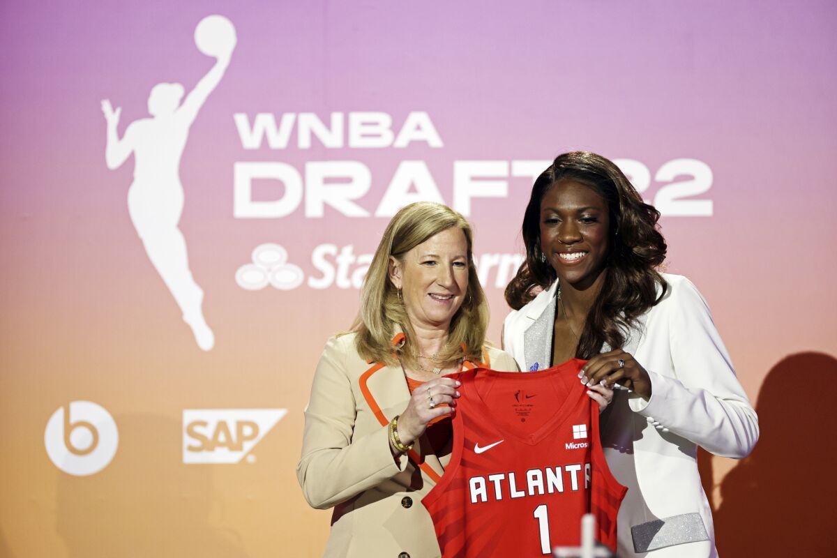 Kentucky's Rhyne Howard, right, poses for a photo with commissioner Cathy Engelbert after being selected by the Atlanta Dream as the first overall pick in the WNBA basketball draft, Monday, April 11, 2022, in New York. (AP Photo/Adam Hunger)