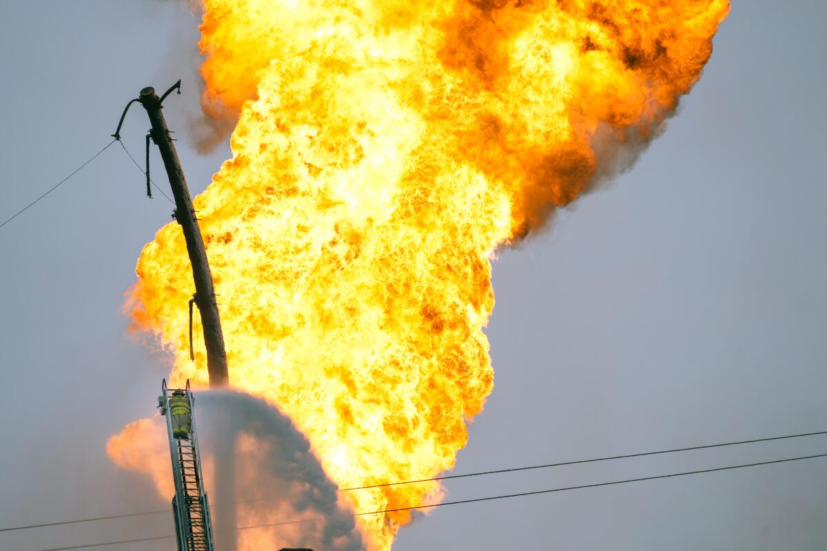 A firefighter directs water toward a pipeline fire in La Porte, Texas.