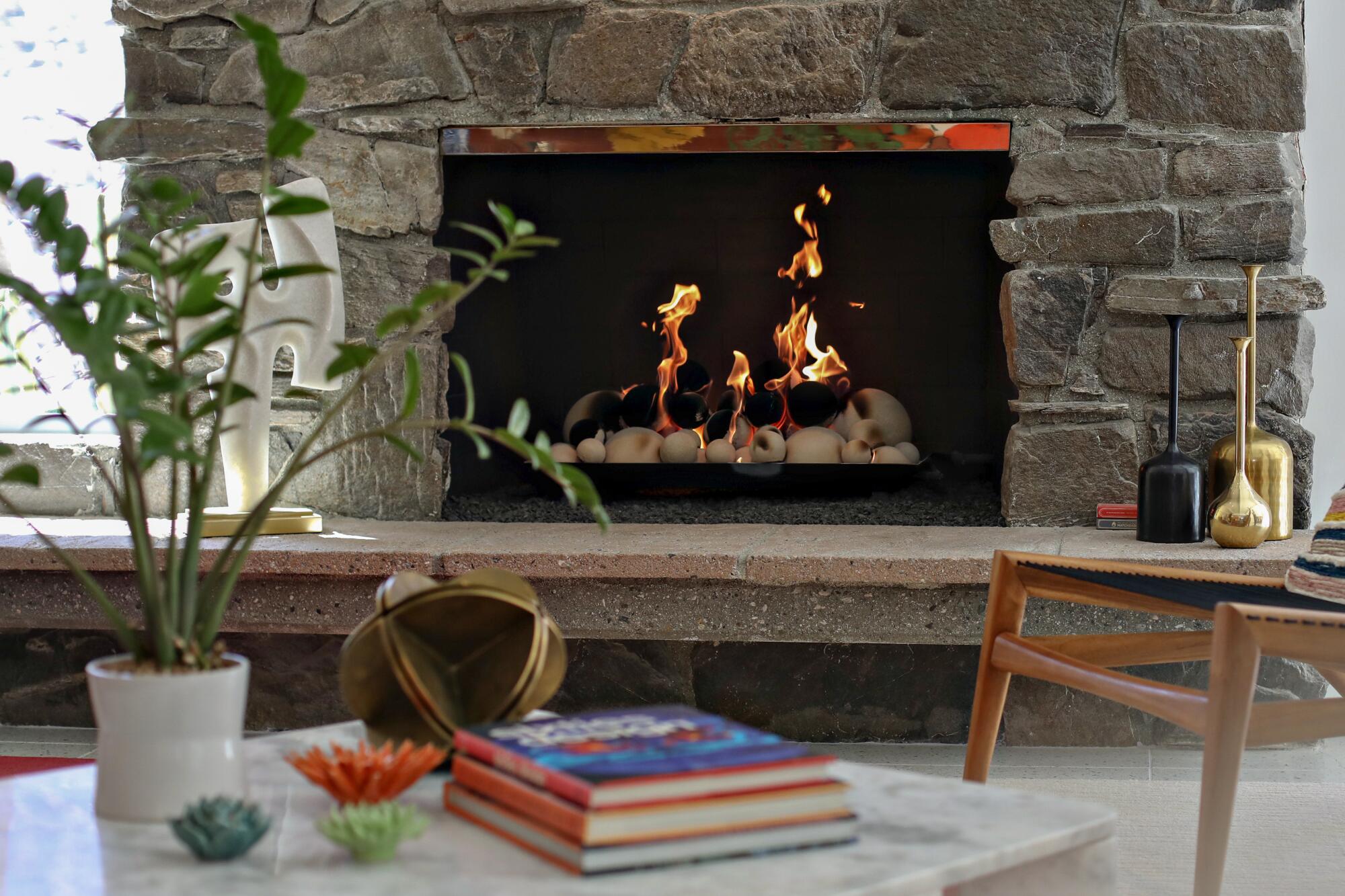 A fireplace with a fire in a living room 