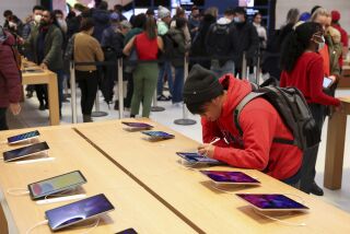 A person shops in an Apple store on Black Friday, Nov. 25, 2022, in New York. (AP Photo/Julia Nikhinson)