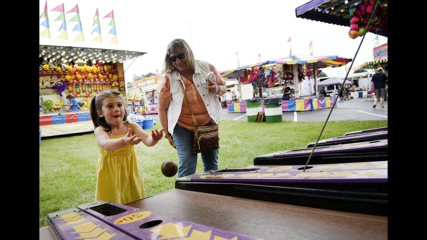 Carol Rethemeyer, right, of Taneytown, coaches her grandaughter Mia Rethemeyer, 4, in a skee ball game on the midway of the Union Bridge fire company carnival Tuesday, May 28, 2019.
