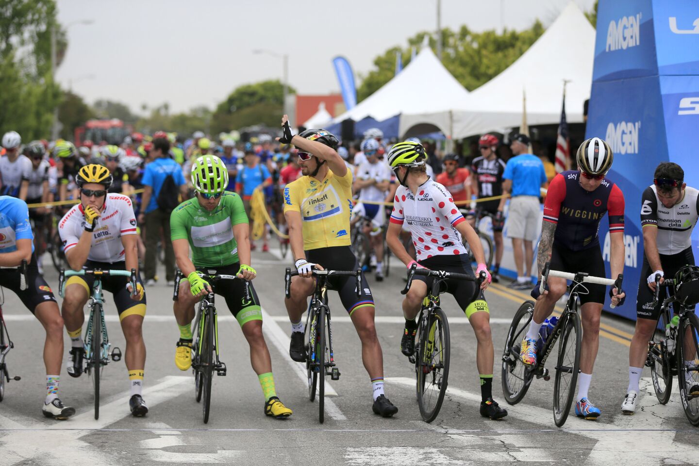 Reigning race champion Peter Sagan, center in yellow jersey, waves to fans as racers prepare to start the second stage of the Amgen Tour of California in South Pasadena on May 16.