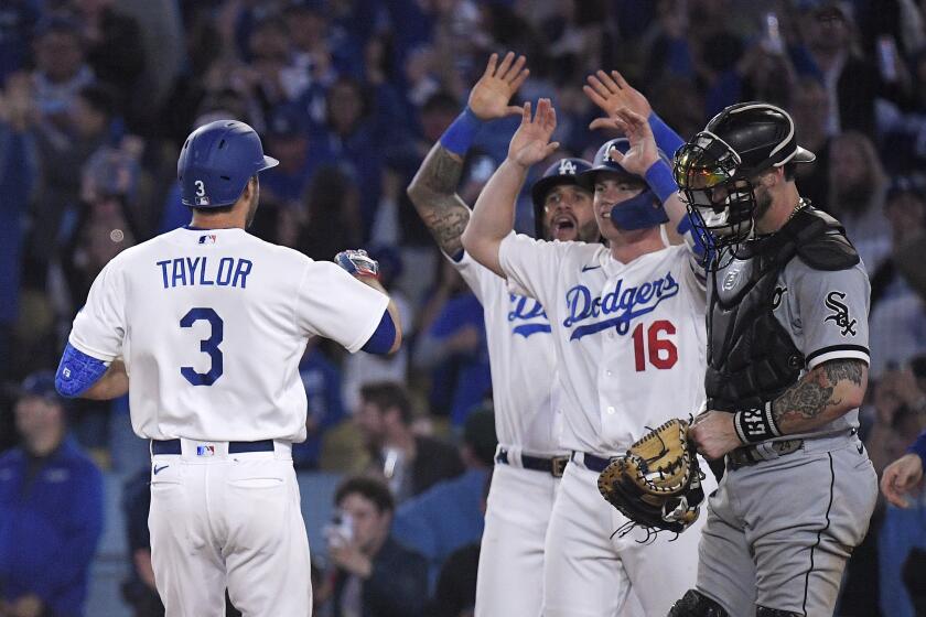Los Angeles Dodgers' Chris Taylor (3) is congratulated by David Peralta (6) and Will Smith (16) after hitting a grand slam as Chicago White Sox catcher Yasmani Grandal stands at the plate during the sixth inning of a baseball game Thursday, June 15, 2023, in Los Angeles. (AP Photo/Mark J. Terrill)