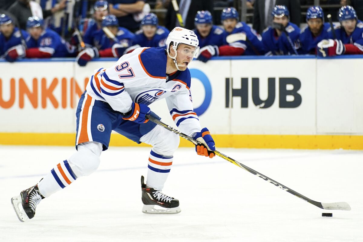 Edmonton Oilers center Connor McDavid skates with the puck during the first period of an NHL hockey game against the New York Rangers, Saturday, Nov. 26, 2022, in New York. (AP Photo/Julia Nikhinson)