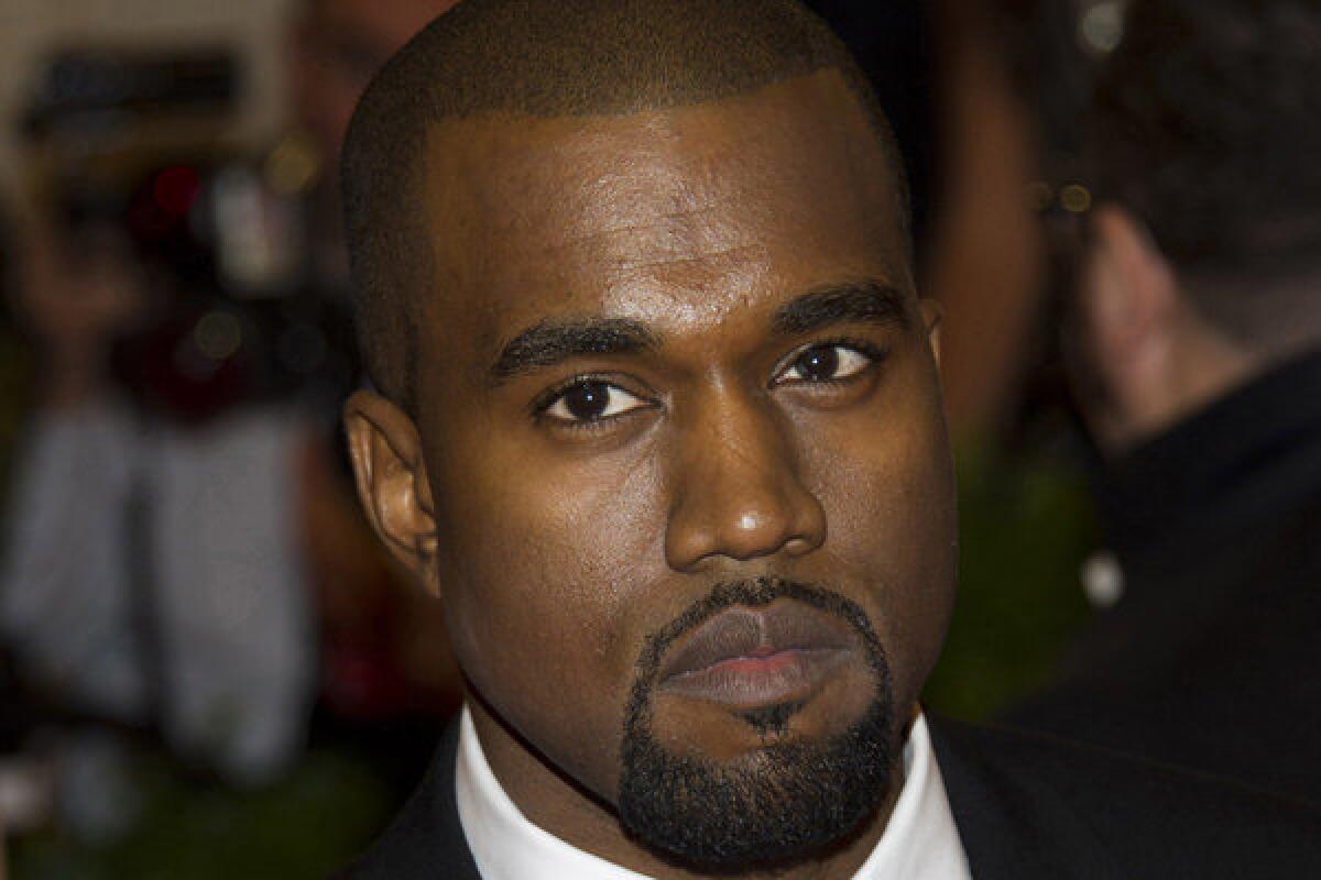 Kanye West allegedly tangled with another photographer outside Los Angeles International Airport on Friday afternoon.