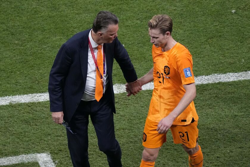 head coach Louis van Gaal of the Netherlands talks with Frankie de Jong as he leaves the pitch during the World Cup group A soccer match between the Netherlands and Qatar, at the Al Bayt Stadium in Al Khor , Qatar, Tuesday, Nov. 29, 2022. (AP Photo/Ariel Schalit)