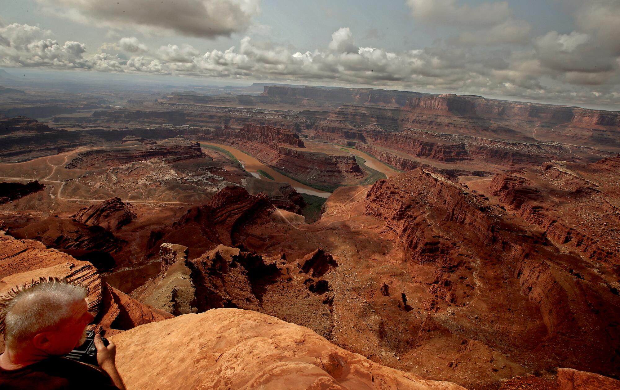  A visitor takes in a view of the Colorado River and Canyonlands National Park at Dead Horse Point near Moab, Utah.