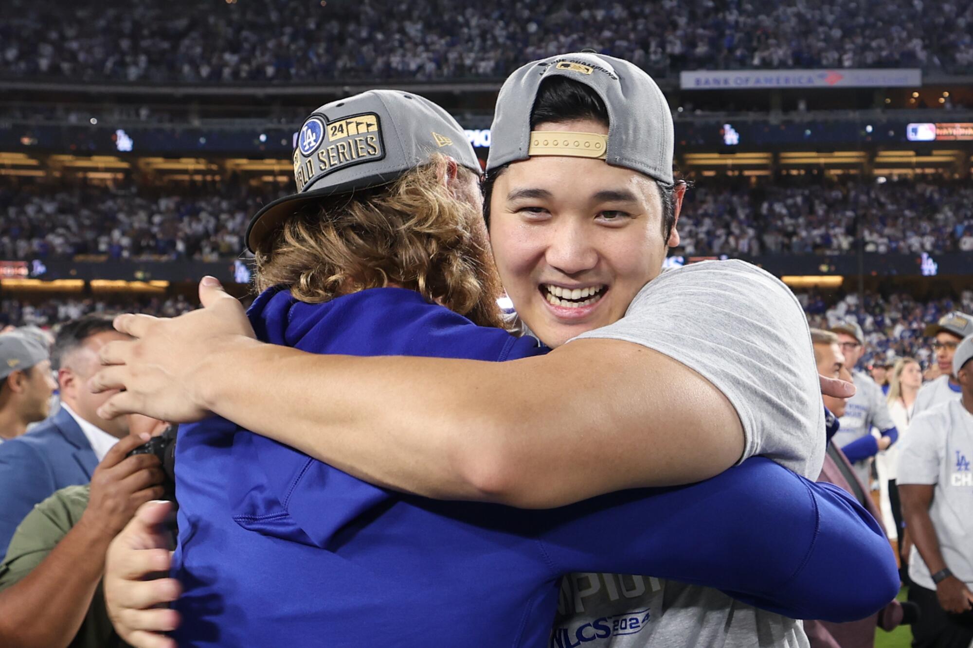 Shohei Ohtani gets hugged after the Dodgers won the NLCS against the Mets on Sunday night at Dodger Stadium.