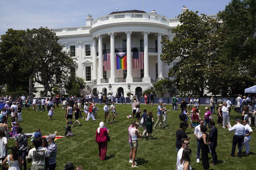 People walk on the South Lawn of the White House during a Pride Month celebration Saturday, June 10, 2023, in Washington. (AP Photo/Manuel Balce Ceneta)