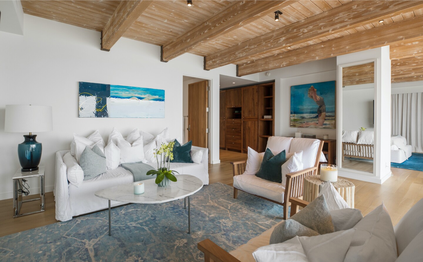 The architectural beach house expands to two levels of wood decks overlooking the ocean.