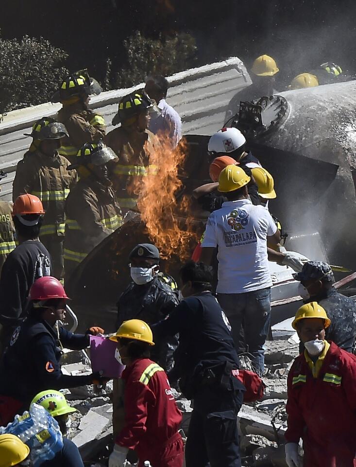 Rescuers work amid the wreckage caused by an explosion in a hospital in Mexico City, on Jan. 29, 2015.