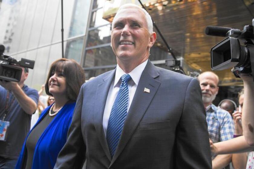 Indiana Gov. Mike Pence and his wife, Karen, leave a meeting with Republican presidential candidate Donald Trump on Friday at Trump Tower in New York.