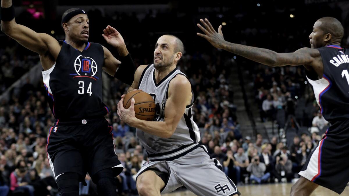 Spurs guard Manu Ginobili (20) drives past Clippers forward Paul Pierce and guard Jamal Crawford during the second half Friday night.