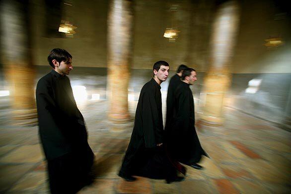 Worshipers walk through the main hall of Church of the Nativity.