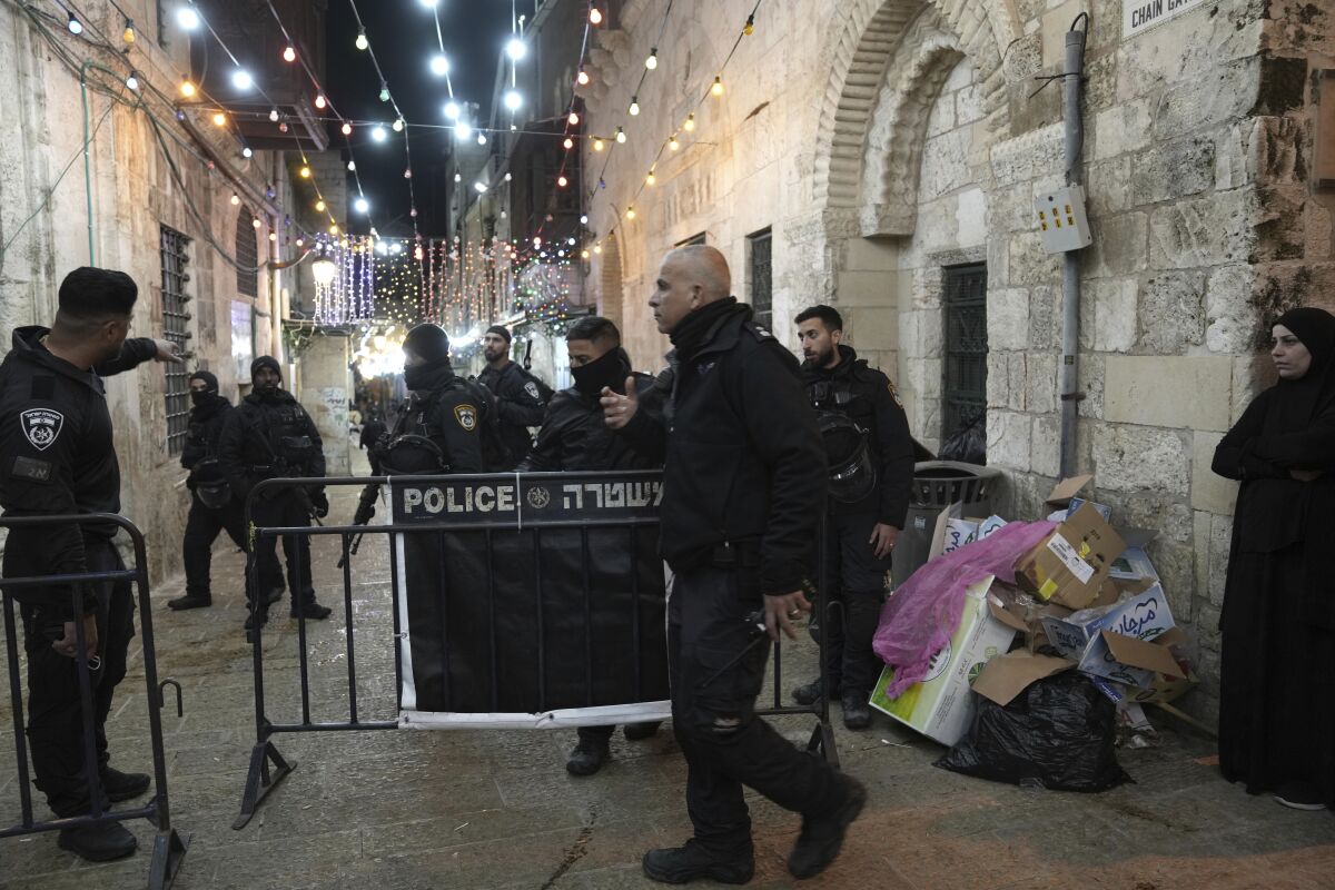 Israeli police close a path leading to the Al-Aqsa Mosque compound after shots were fired in the Old City of Jerusalem during the Muslim holy month of Ramadan, Saturday, April 1, 2023. (AP Photo/ Mahmoud Illean)