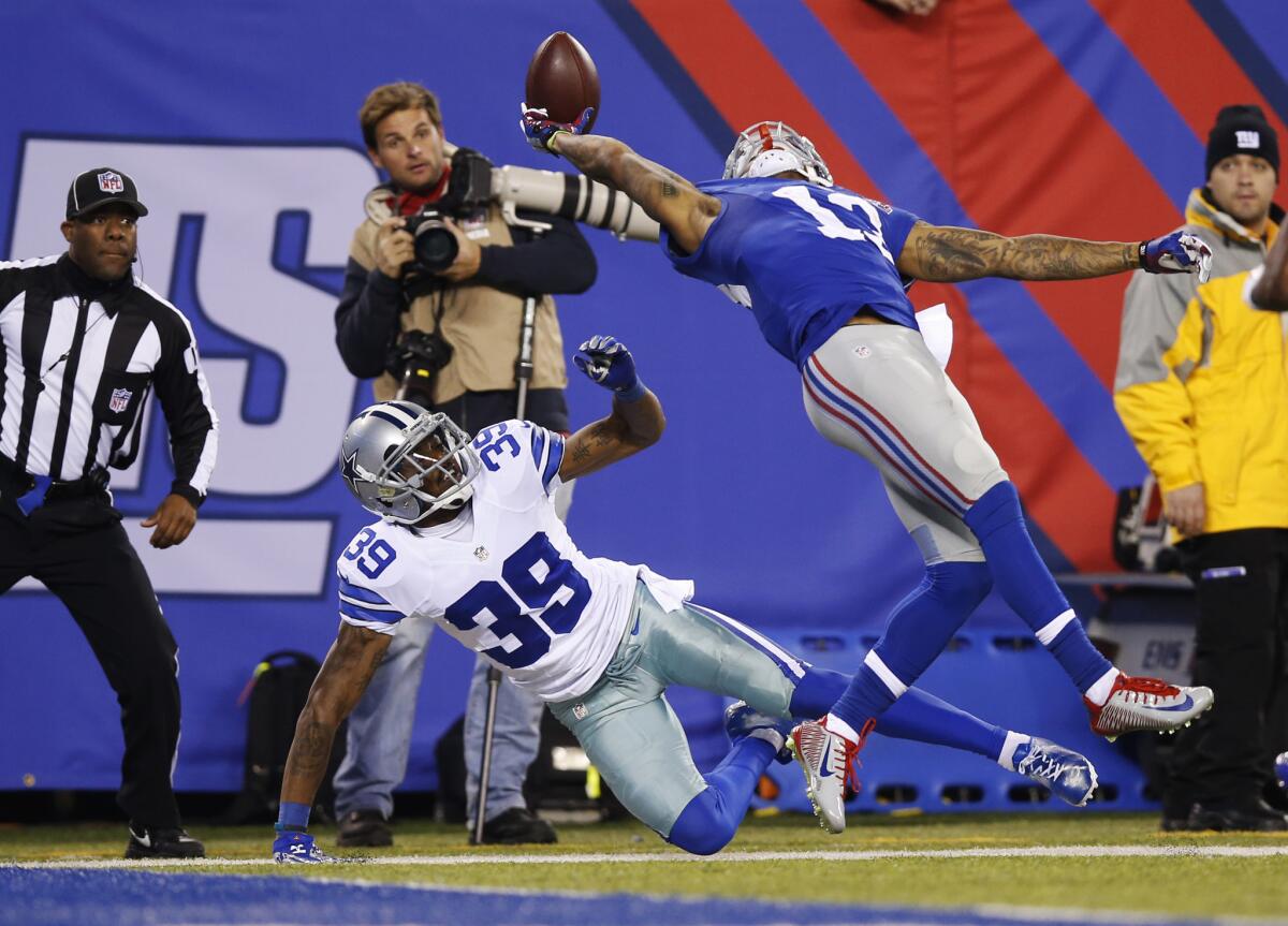 New York Giants wide receiver Odell Beckham Jr. makes a one-handed catch for a touchdown against Dallas Cowboys cornerback Brandon Carr on Nov. 23, 2014.