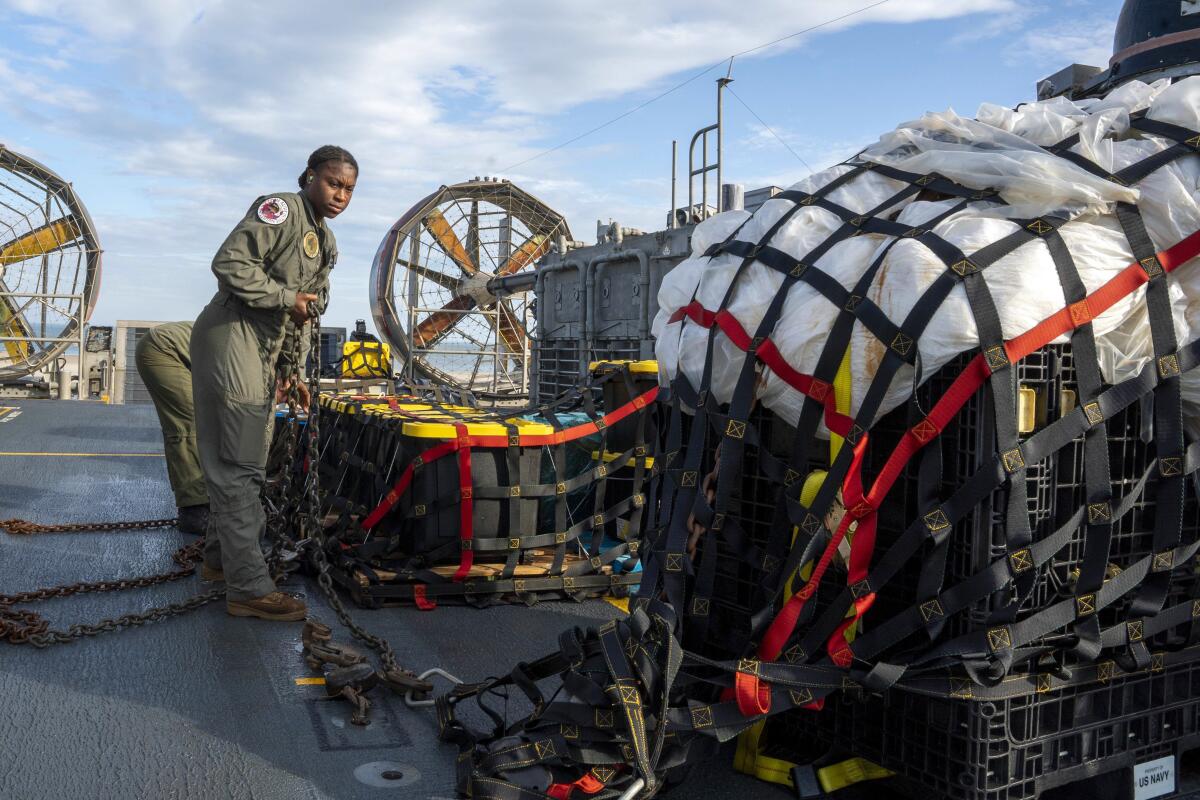 Navy sailors prepare material recovered off the coast of Myrtle Beach, S.C., in Virginia Beach, Va., on Feb. 10, 2023.