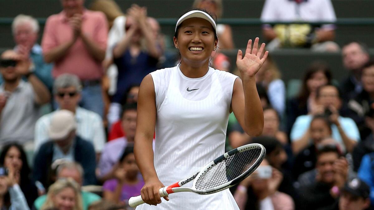Claire Liu acknowledges the cheers after defeating Ann Li to win the Wimbledon girls' singles title Sunday.