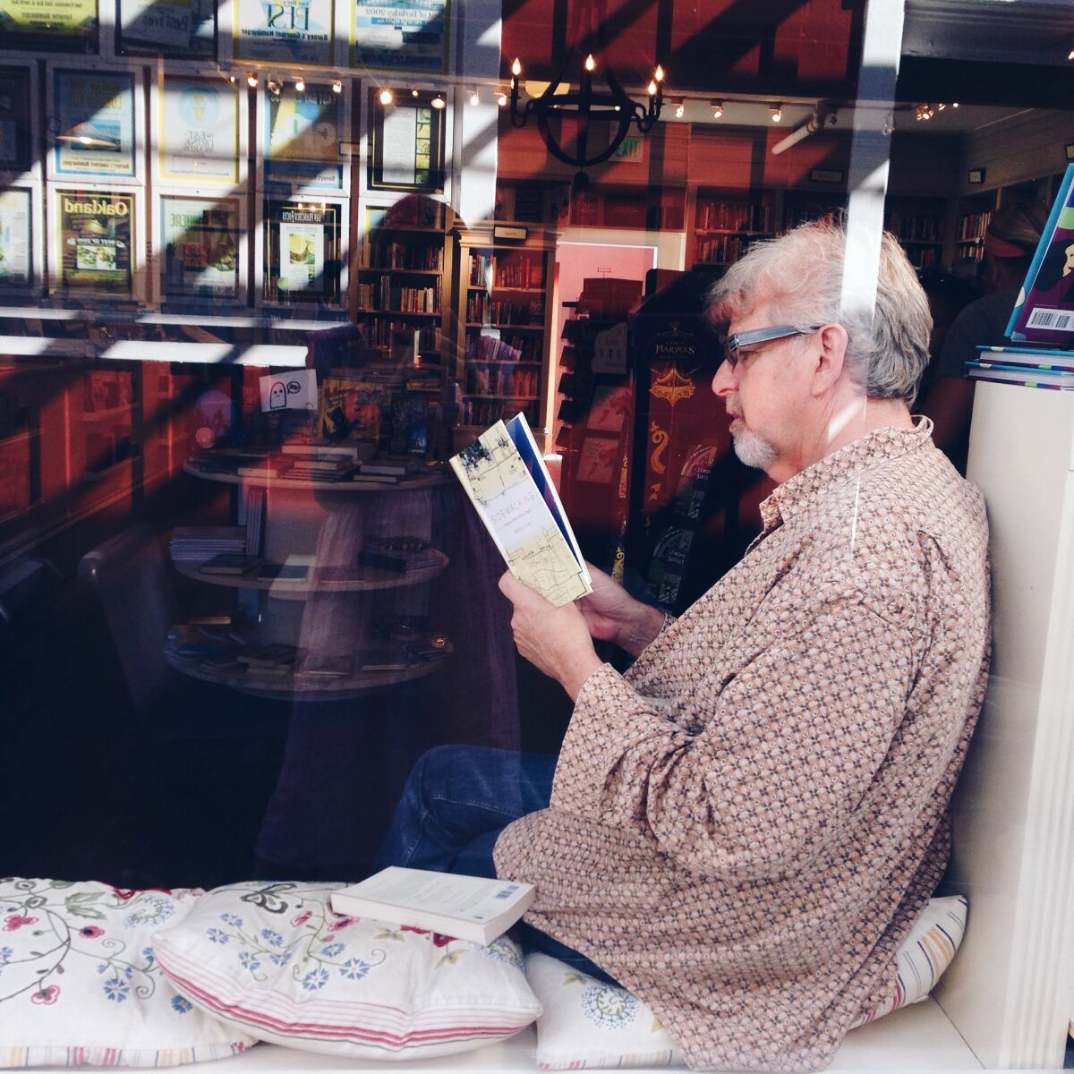 A reader in the window of the DIESEL, A Bookstore in Brentwood. The book store will open in Carmel Valley on Oct. 28.