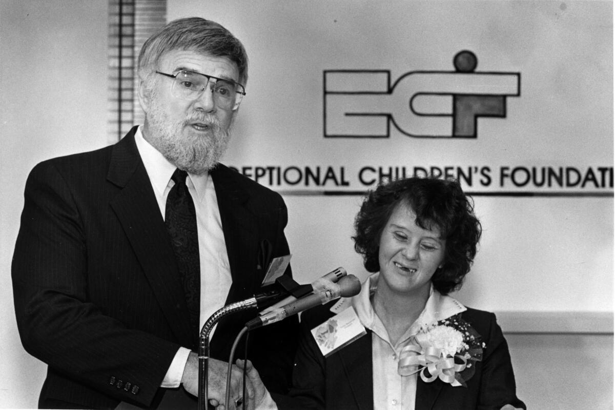 Robert Shushan, executive director of the Exceptional Children's Foundation, celebrates with Terry Westbrook, who was chosen to accept a national award honoring the organization for the developmentally disabled, in 1988.