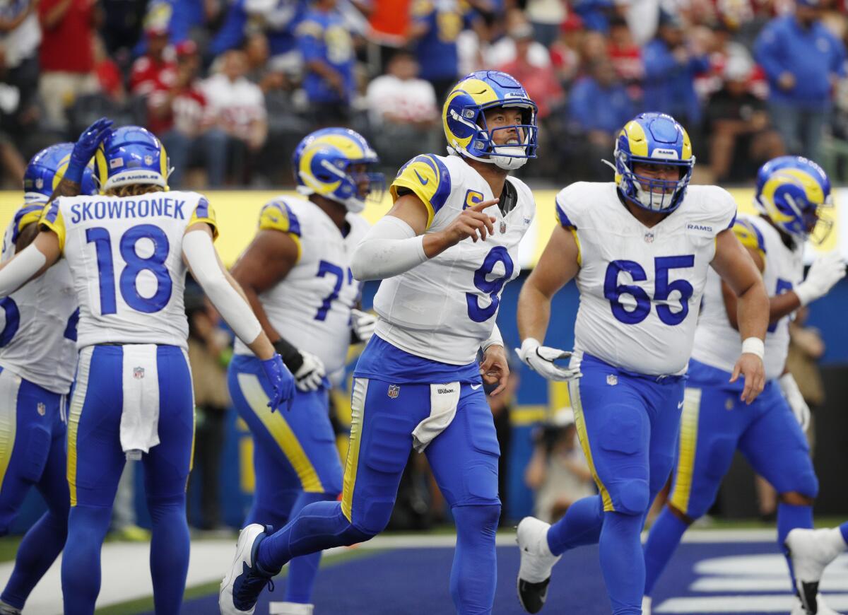 Rams quarterback Matthew Stafford runs back to the sideline after a touchdown against the 49ers.