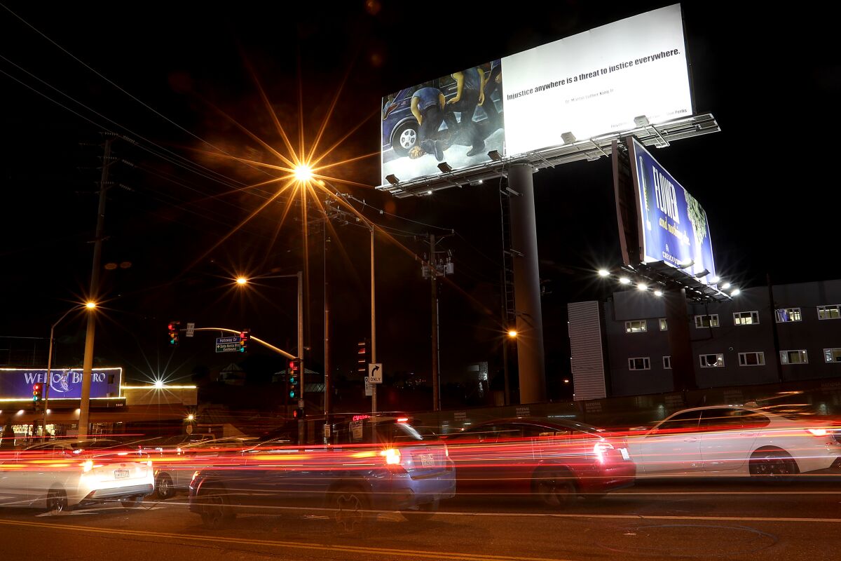 La Cienega Boulevard and Holloway Drive in West Hollywood beneath a billboard depicting the death by cop of George Floyd.