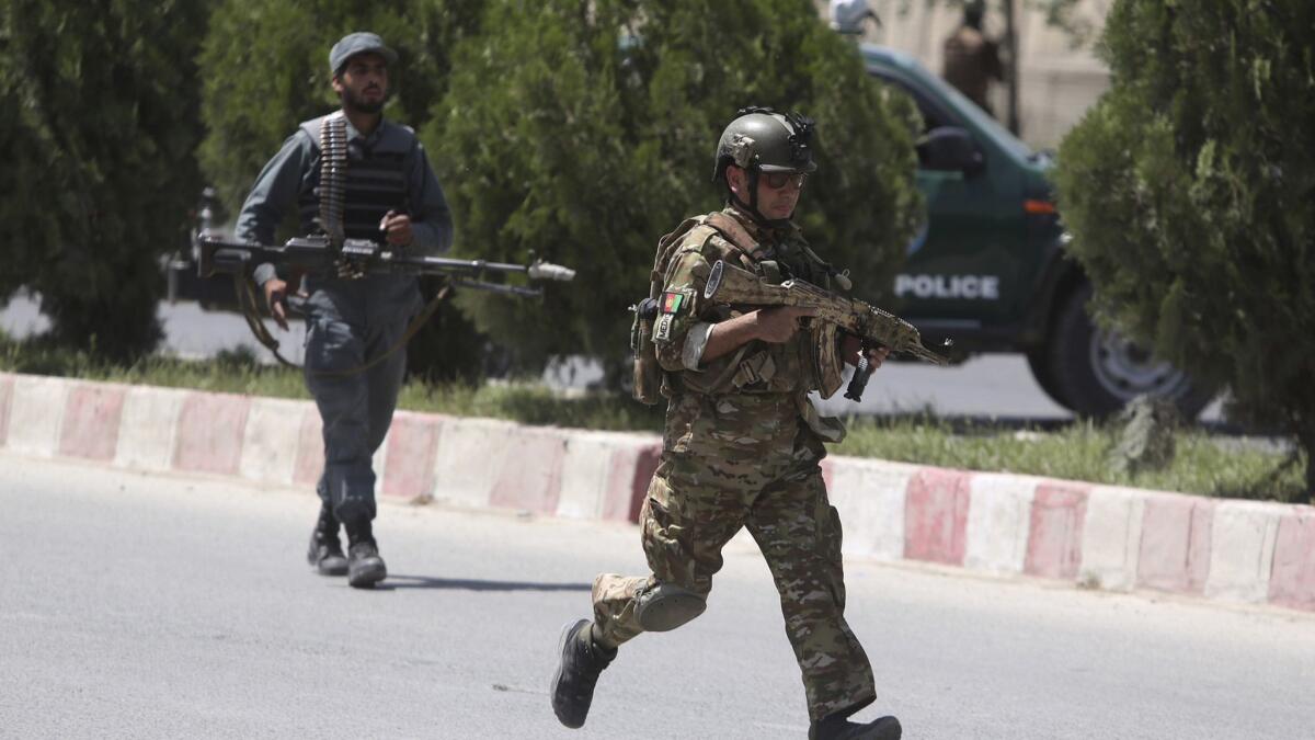 Security personnel arrive at the site of an attack at the Afghan Interior Ministry in Kabul on May 30.