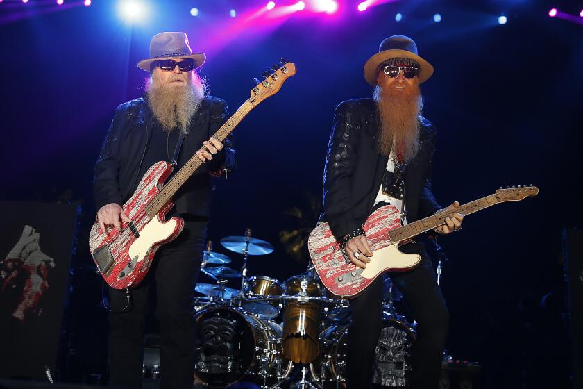 INDIO, CA APRIL 25, 2015: ZZ Top bassist Dusty Hil, left, and guitarist Billy Gibbons perform on the Palomino Stage on the second day of the three-day Stagecoach Country Music Festival at the Empire Polo Club in Indio Saturday, April 25, 2015. Carroll said their mission is to bring a piece of American depression-era history to America. Stagecoach is the highest grossing and biggest-attendance country music festival, Pollstar reports. (Allen J. Schaben / Los Angeles Times)