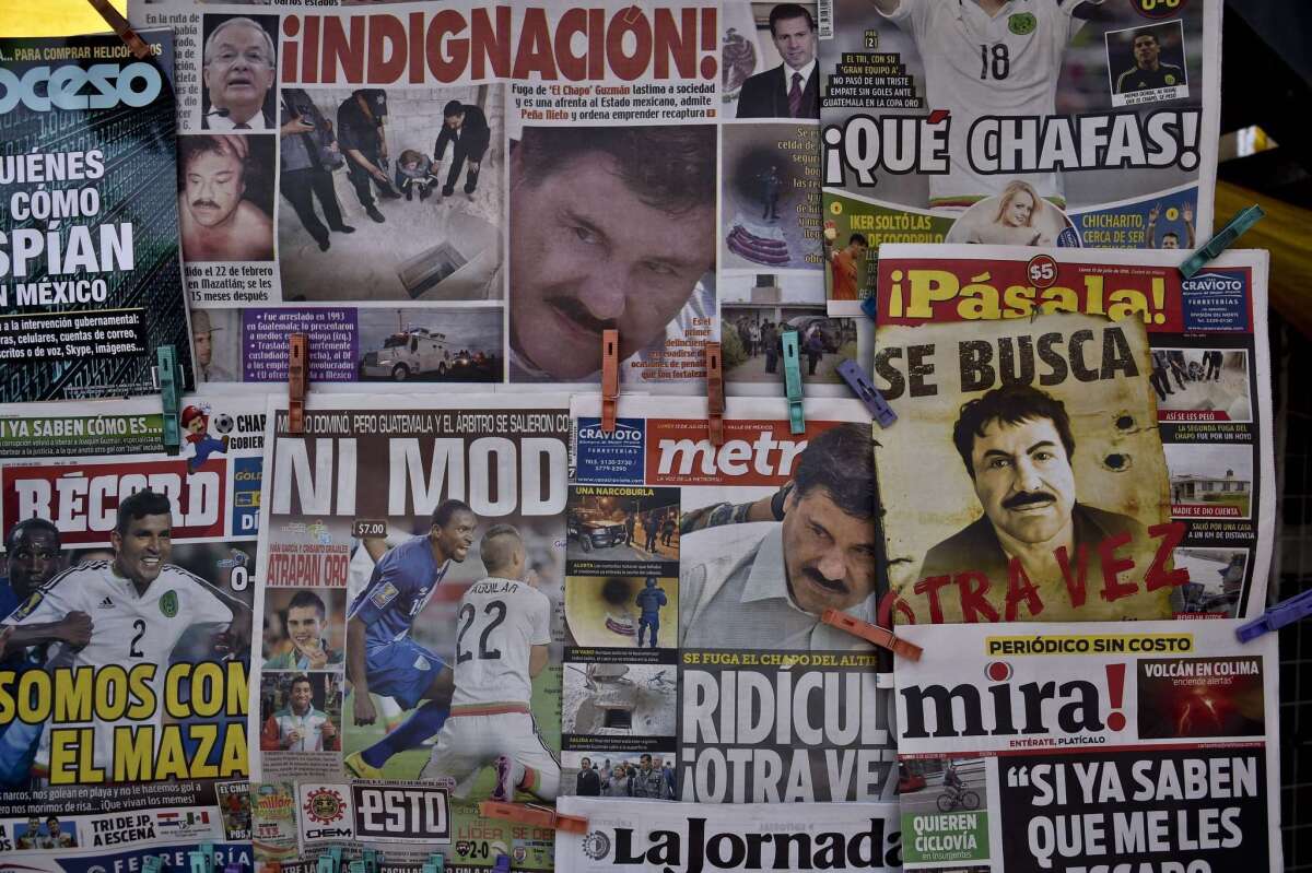 A newspaper with a poster of Mexican drug lord Joaquin "El Chapo" Guzman reading "Wanted, Again" (“Se busca, otra vez”), right, is displayed at a newsstand in one of Mexico City's major bus terminals on July 13.