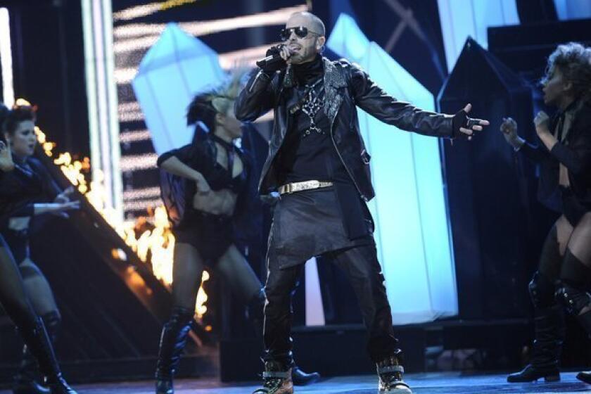 Yandel rocks the stage amid his backup dancers.