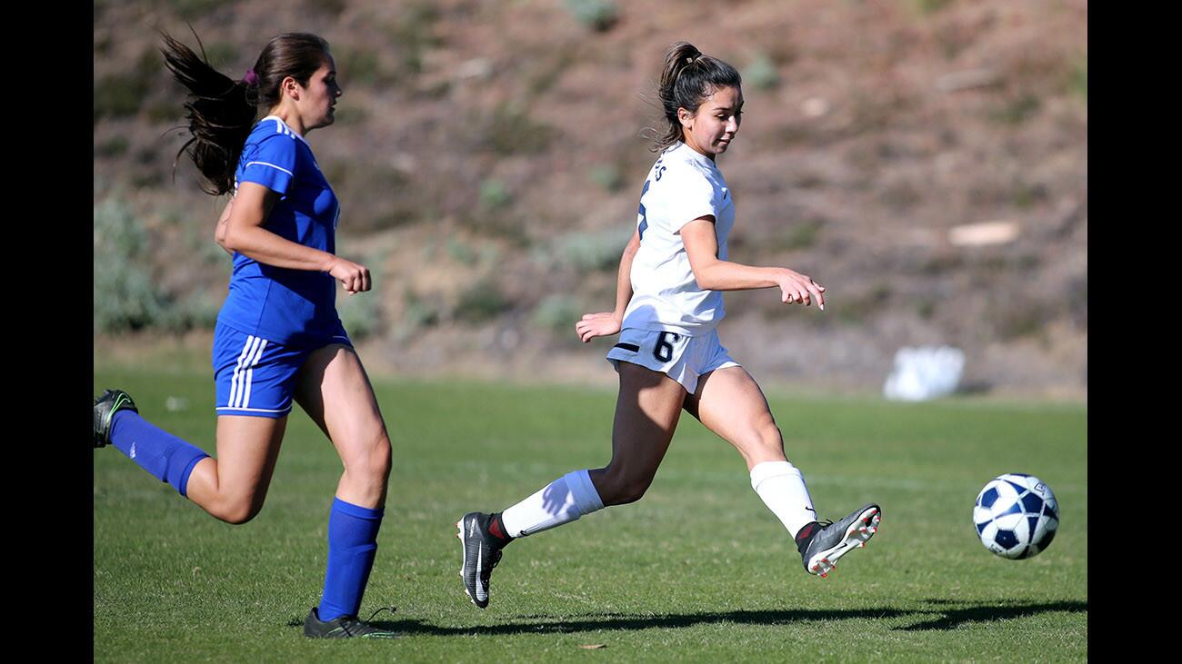 Flintridge Prep girls soccer player #6 Julia Gonzalez takes a shot on goal as she is chased down by #18 Jordan Weiss in CIF SS Div. III second round playoff game vs. Culver City High School at Occidental College in Eagle Rock on Tuesday, Feb. 20, 2018.