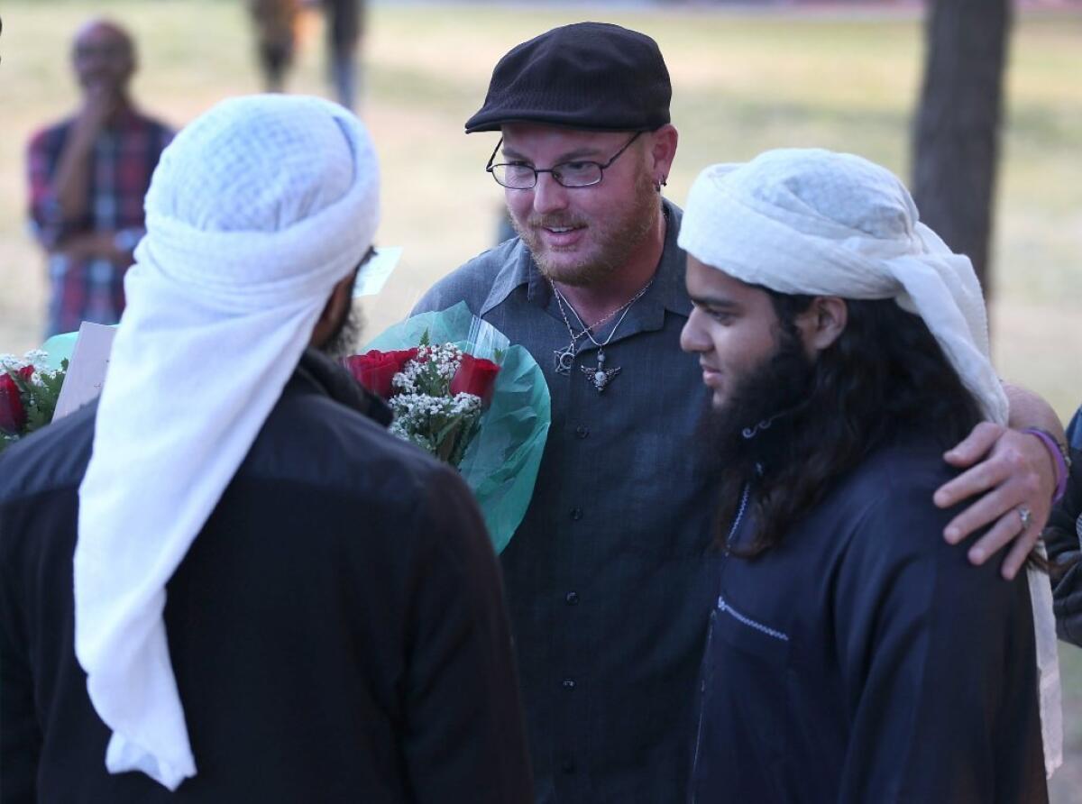 Ryan Reyes, center, speaks with Nizaam Ali, left, and Rahemaan Ali, who came to pay their respects during a memorial service for Ryan's boyfriend, Daniel Kaufman, who was killed in the mass shooting last month at the Inland Regional Center in San Bernardino.