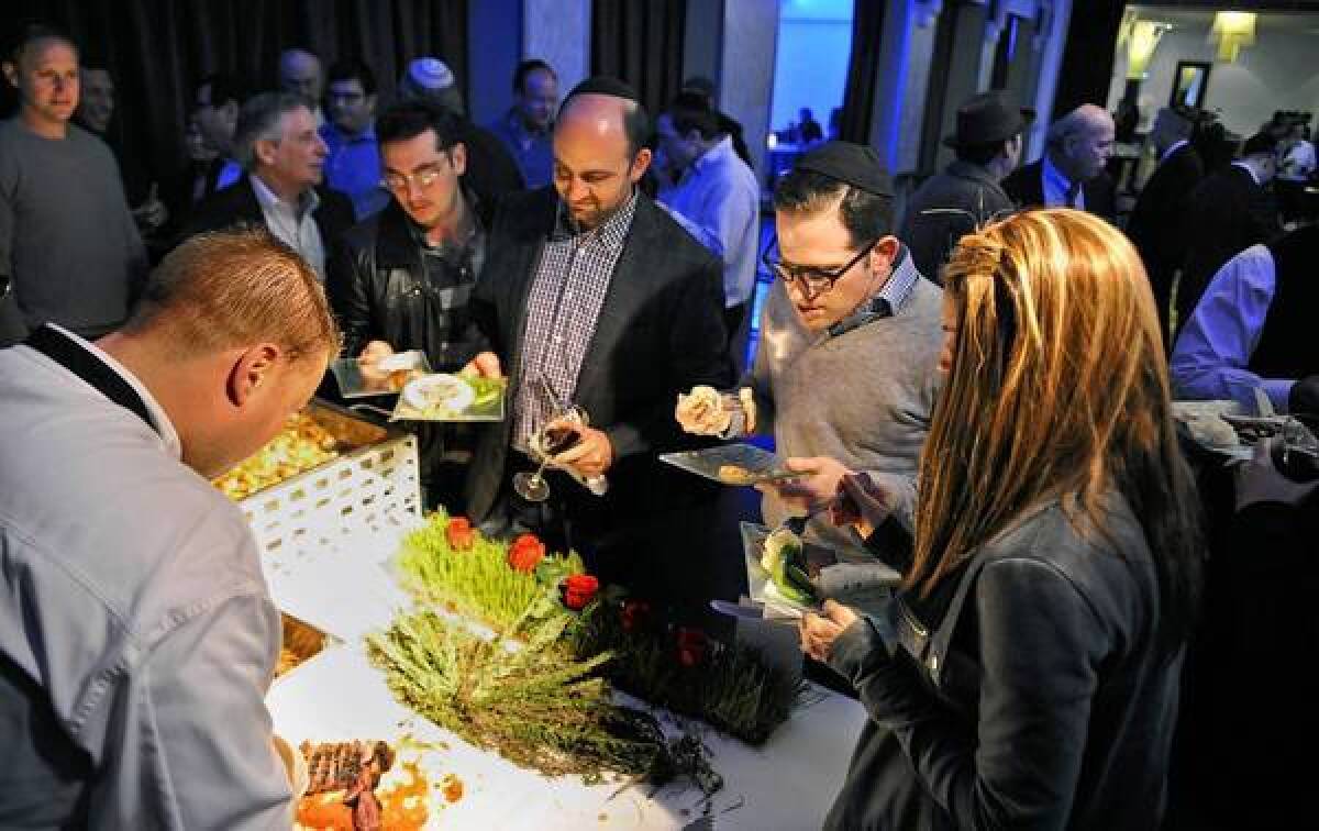 Diners line up for tri-tip at a Beverlywood Supper Club dinner at the Mark.