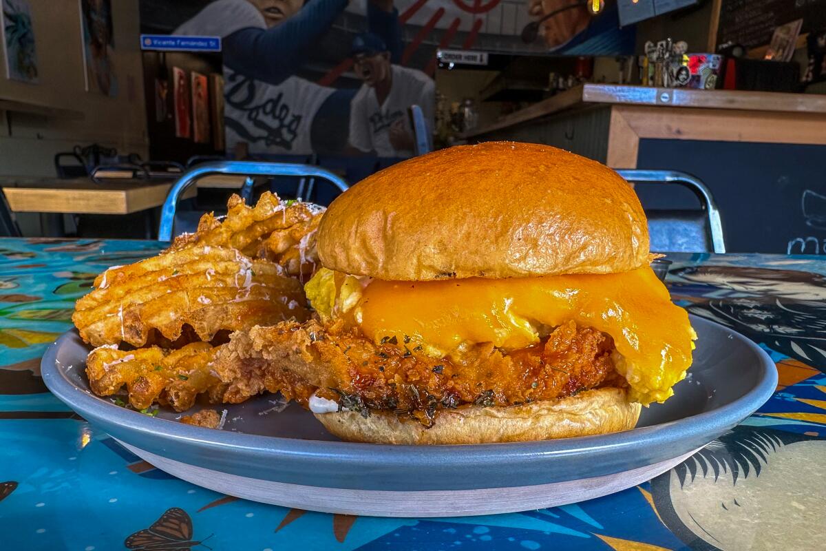 Fried chicken sandwich with cheesy soft-scrambled eggs at Jonathan Perez's Distrito Catorce pop-up in Boyle Heights.