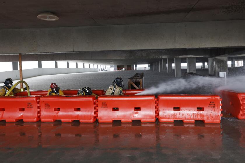 Chula Vista, CA - May 20: Chula Vista firefighters take part in a simulated high rise fire exercise in a parking structure at the Gaylord Pacific Resort & Convention Center under construction on Chula Vista's Bayfront during a multi-agency high rise fire training on Monday, May 20, 2024 in Chula Vista, CA. Lead by Chula Vista Fire Department, approximately 500 firefighters from San Diego, Coronado, National City, Bonita and Imperial Beach fire departments will take part in the high rise fire safety training over ten days at the new complex. (K.C. Alfred / The San Diego Union-Tribune)