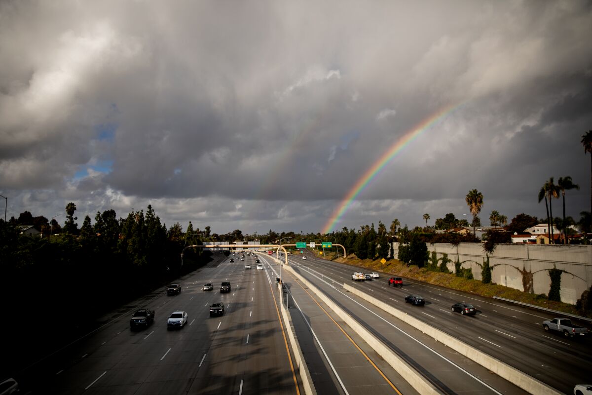 A rainbow forms over Interstate 15