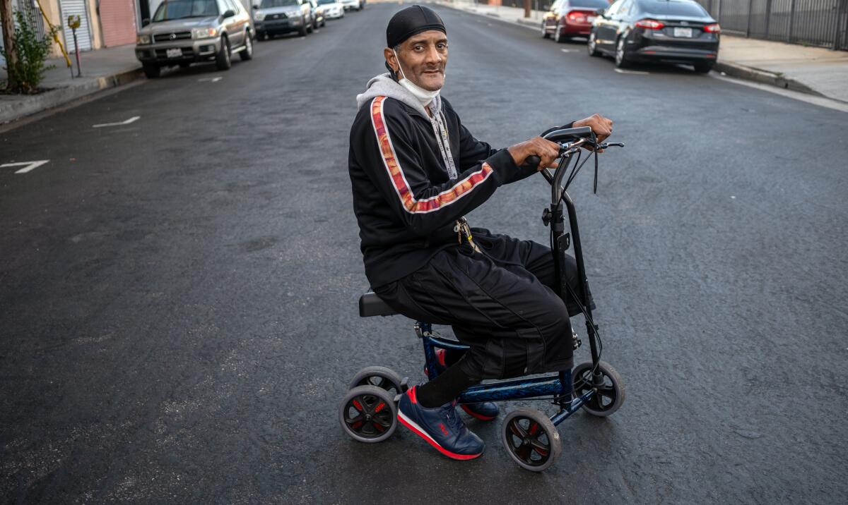 Marvin Danzey III, 58, sits in his scooter  outside the Lincoln Hotel on Skid Row in September