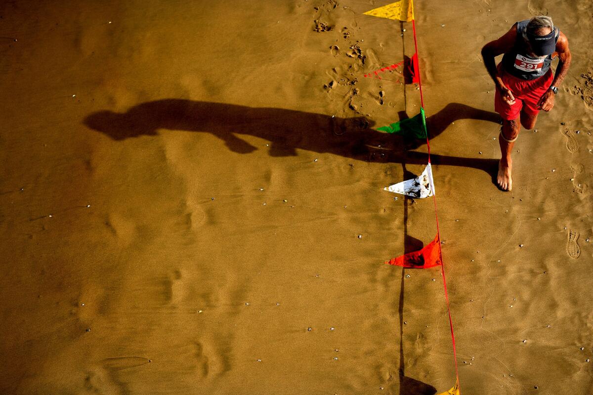 A lifeguard competes in the Dick Fitzgerald Beach Run.