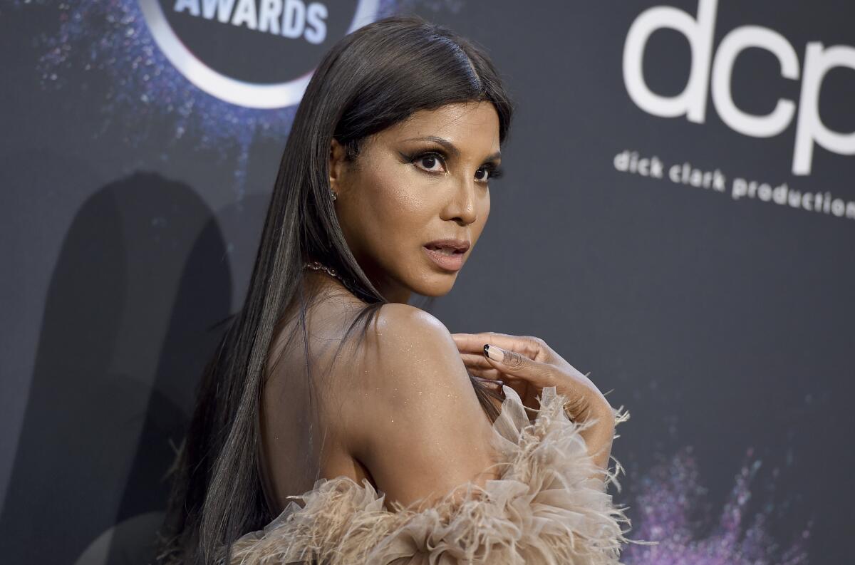Toni Braxton in a feathered brown strapless dress