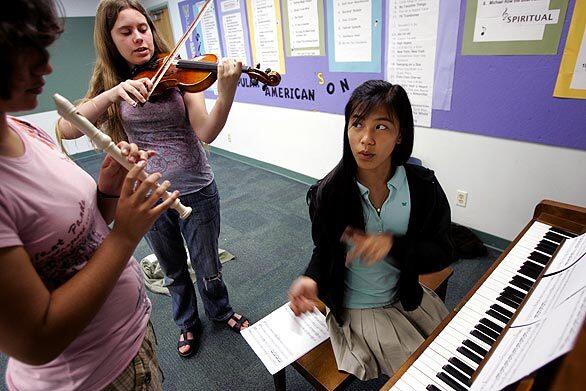Ellen Bowker, 14, from left, Lily Desmond, 13, and Gianna Horak,14, practice "Graduation," a piece composed by Gianna at the Waverly School in Pasadena. The piece was performed at the school's graduation this month. Gianna is on a monthlong tour of China, where she was born, with the Los Angeles Children's Chorus.