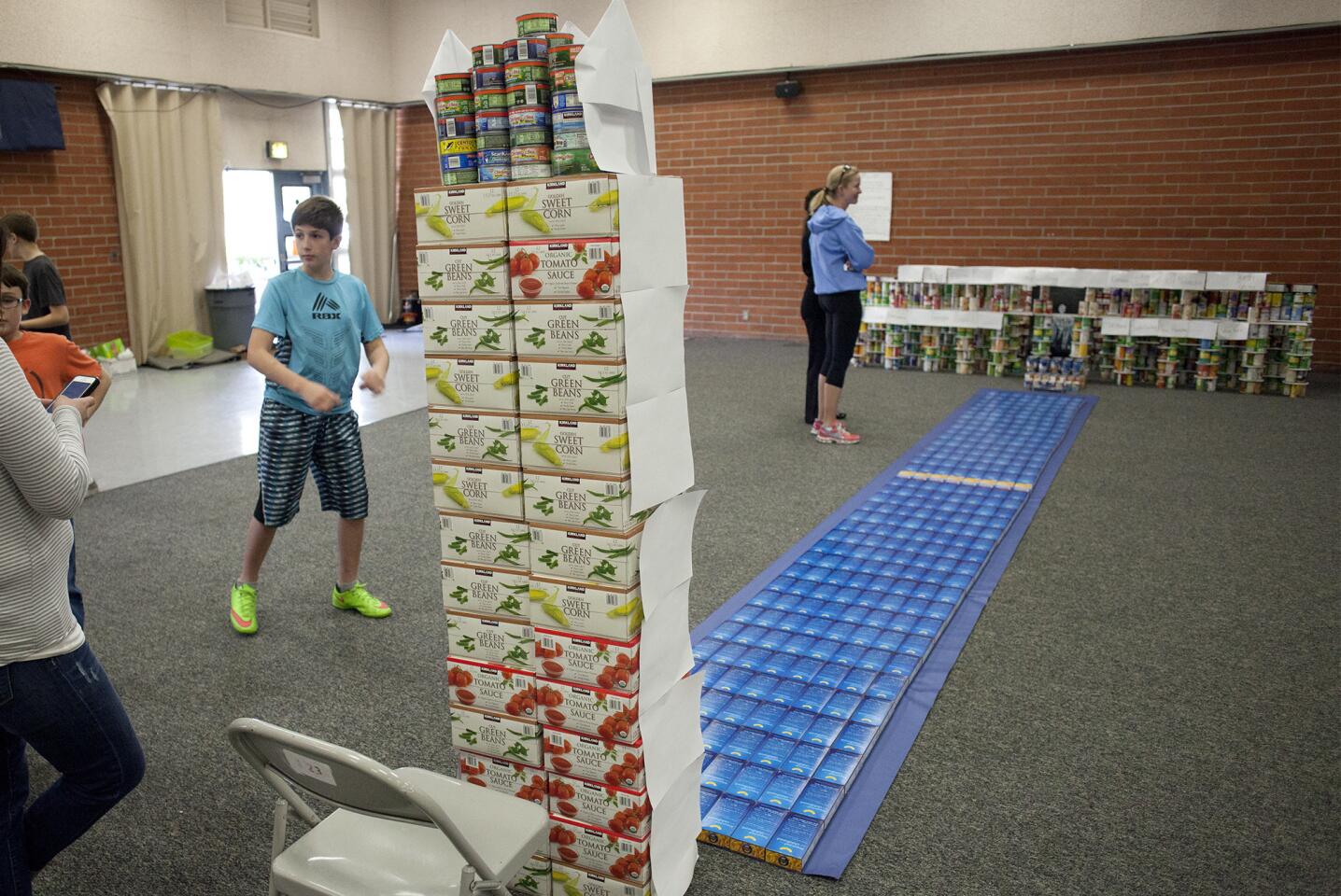 Lincoln Elementary School students construct a replica of the Lincoln Memorial, which includes the Reflecting Pool and Washington Monument, from cans and food boxes.