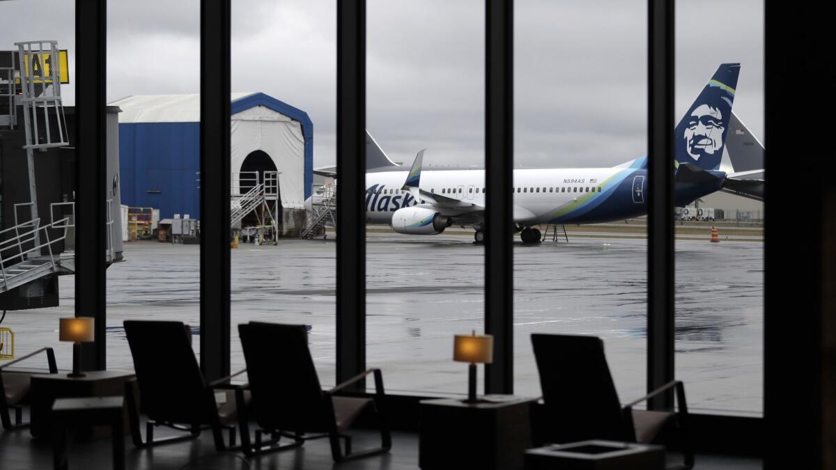 An Alaska Airlines plane sits outside the new passenger terminal at Paine Field in Everett, Wash. Alaska is offering $193 round-trip tickets to the airport, which is an alternative to Sea-Tac, for travel beginning March 5.