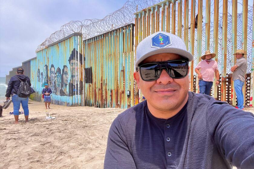 U.S. veteran Ramon Castro, by Tijuana border fence, begins a 1,954-mile walk June 28 to focus on needs of deported U.S. vets.