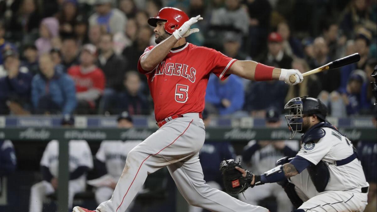 Angels' Albert Pujols takes a swing during the eighth inning against the Seattle Mariners.