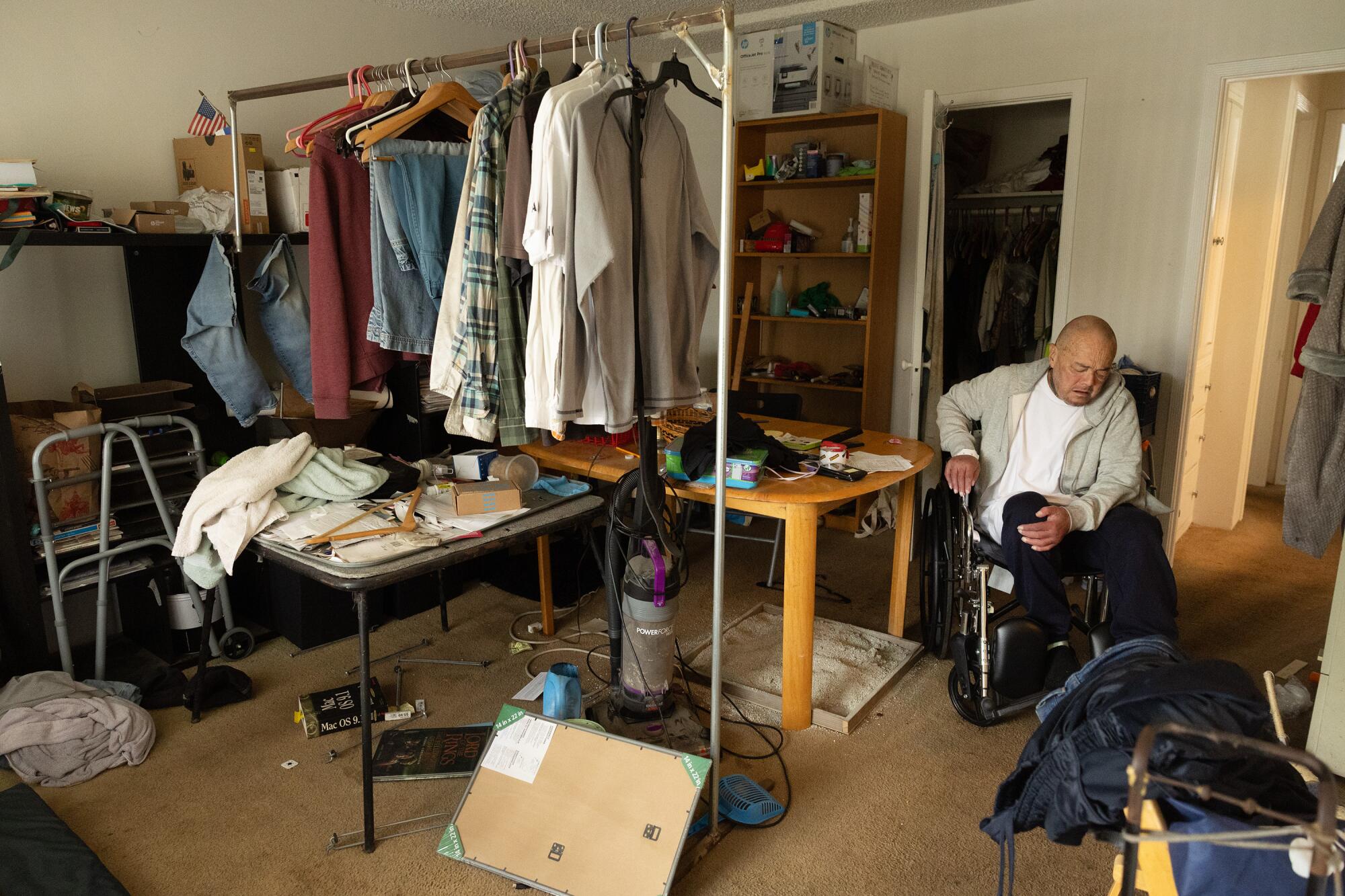 A man is sitting in a wheelchair in the room.